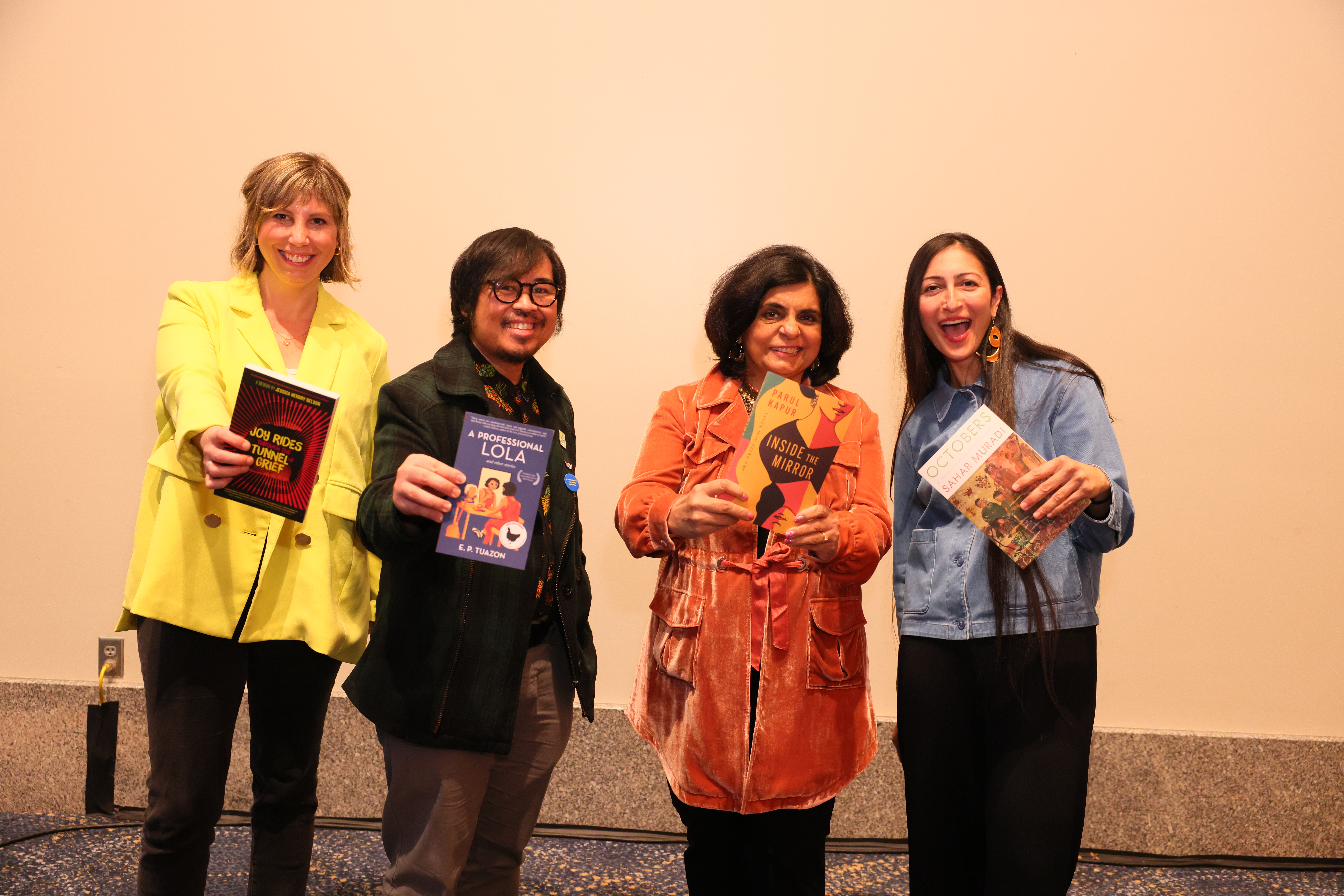 The four winners of the 2022 AWP Award Series holding their published books