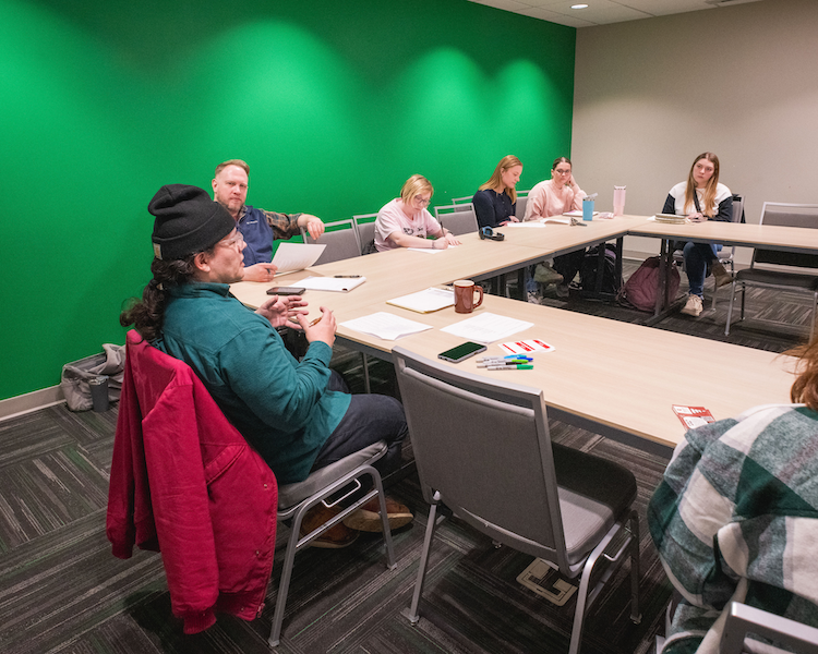Several people sitting in a classroom