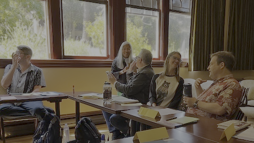 People smiling and chatting in a classroom