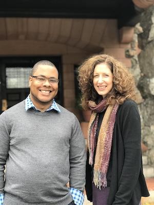 Meg Kearney standing and smiling with Associate Director Quintin Collins